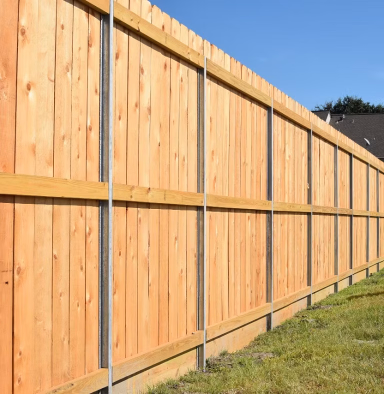 Newly installed wooden fence in residential yard