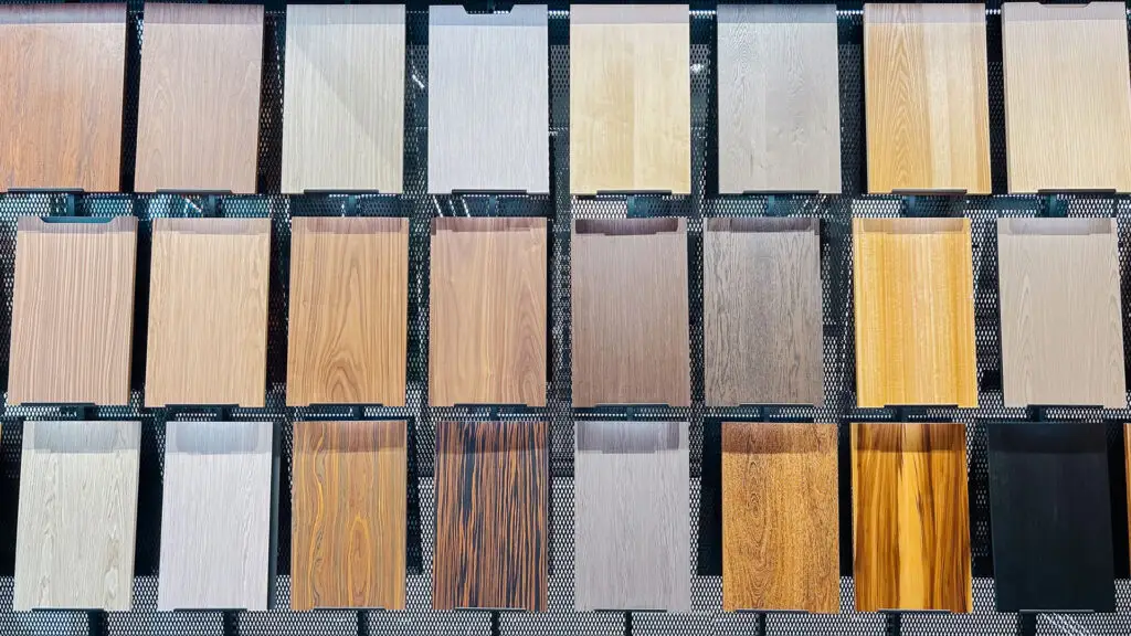 Display of luxury vinyl plank flooring samples in various wood tones and finishes