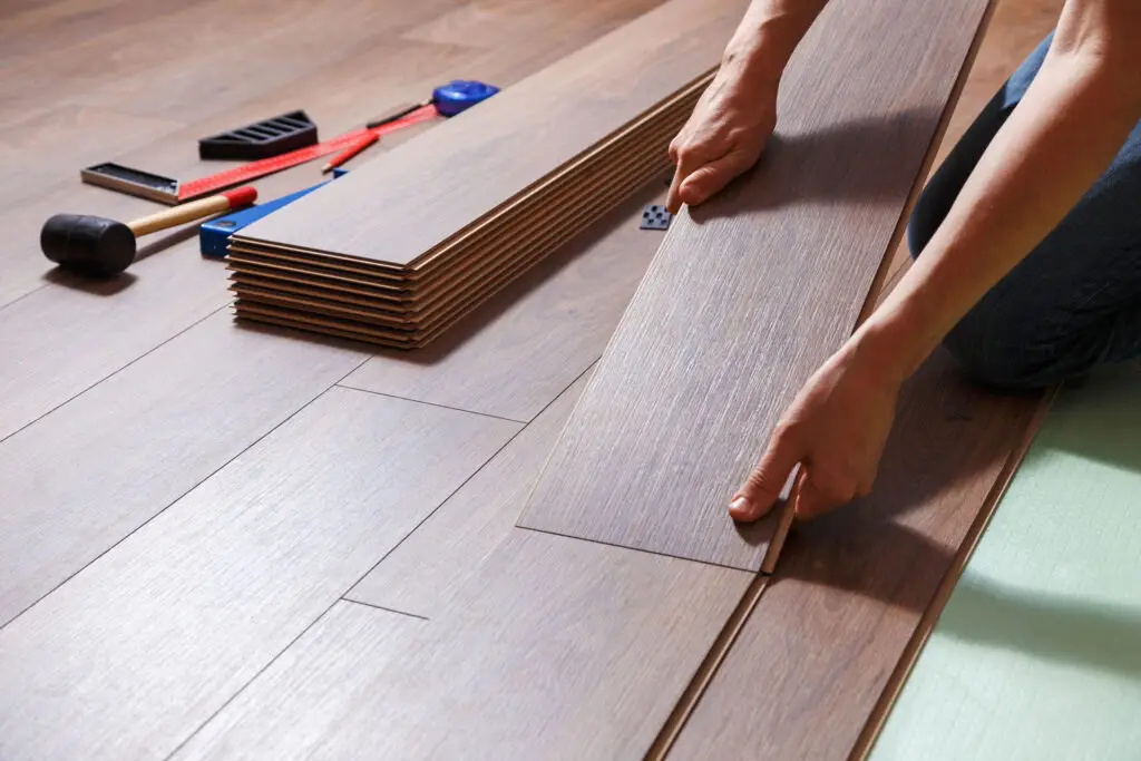 Close up installation of luxury vinyl plank flooring
