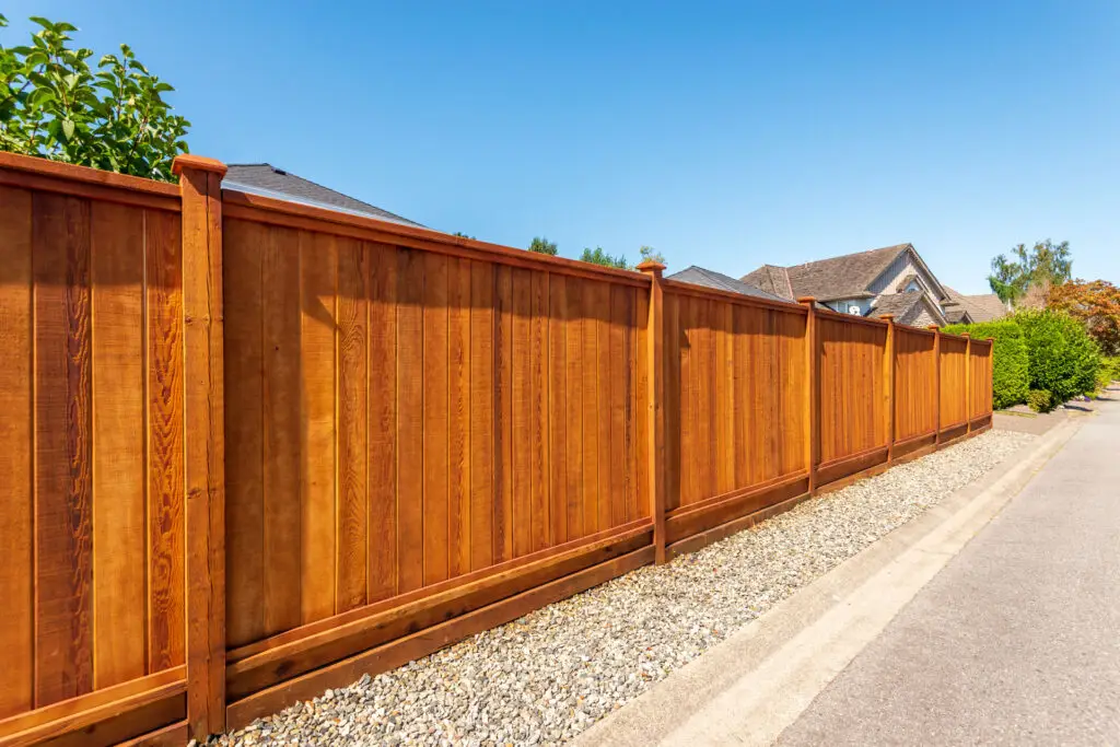 Wooden privacy fence installation surrounding residential property