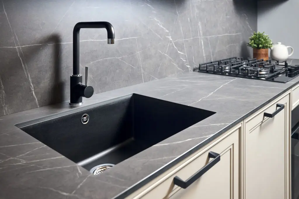 Contemporary kitchen with dark stone countertop installation