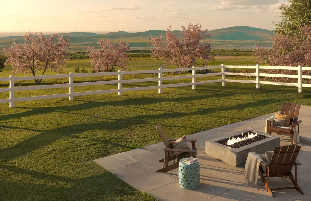 White ranch-style vinyl fence surrounding backyard