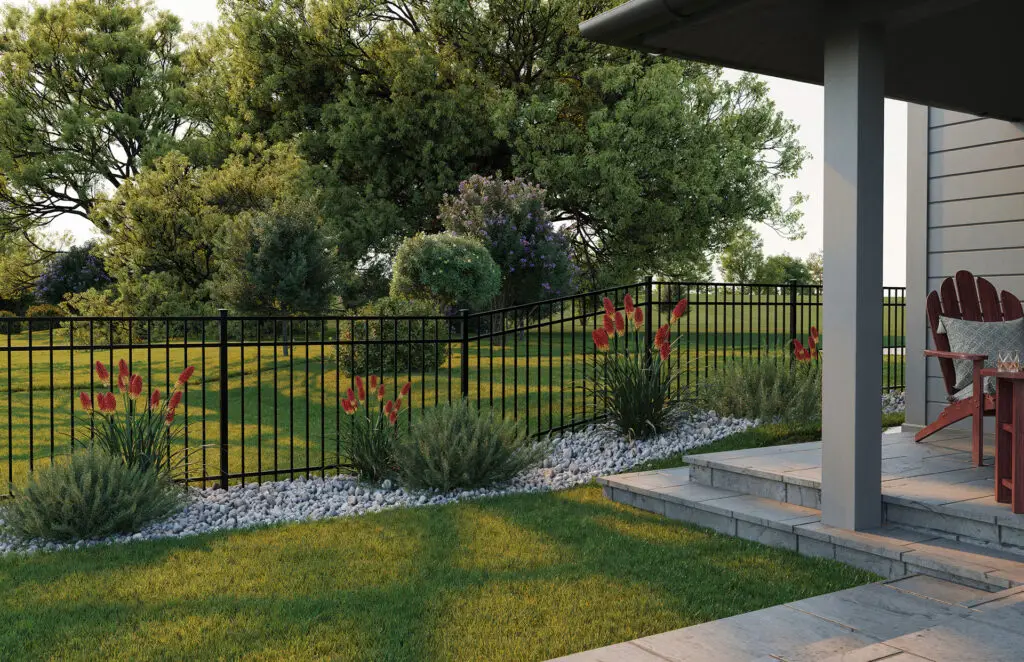 Black aluminum fence surrounding landscaped backyard