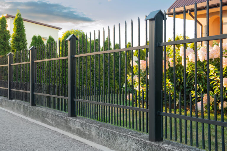 Black iron fence near pathway outdoors